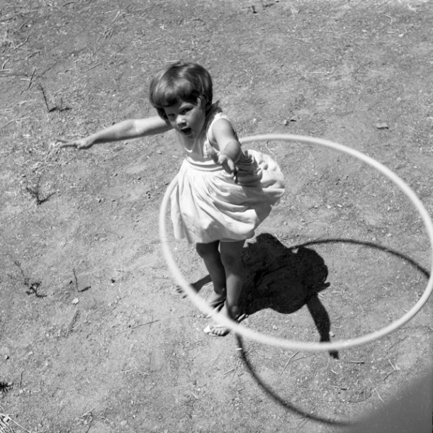 Girl_twirling_Hula_Hoop,_1958