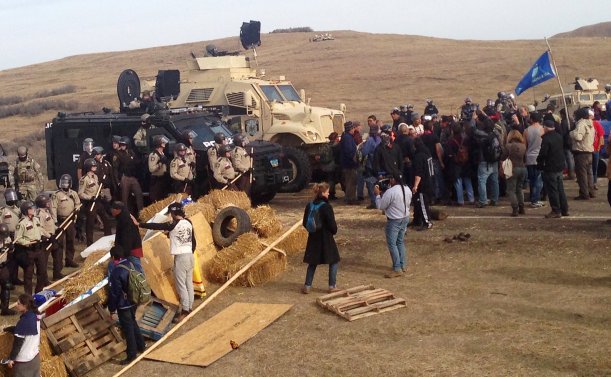 A line of police move towards a roadblock and encampment of Native American and environmental protesters near an oil pipeline construction site, near the town of Cannon Ball, North Dakota, U.S. October 27, 2016. REUTERS/Rob Wilson